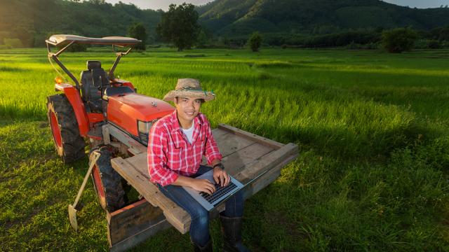 Young farmer sitting on a tractor