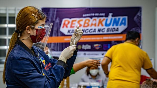 A woman preparing a COVID-19 vaccine jab in the Philippines