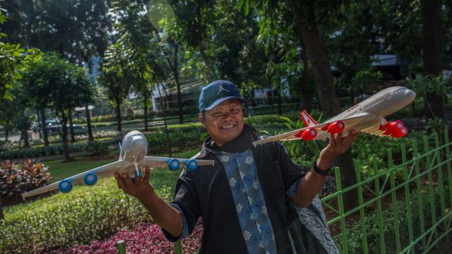 Indonesian vendor selling toy aircraft