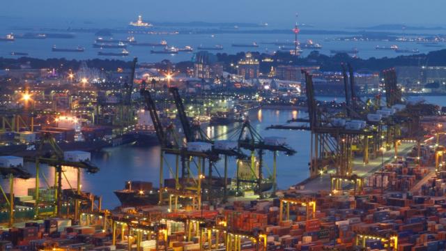 Ships wait to load and unload cargo at the Keppel Bay container terminal on 13 July 2011. Singapore is home to one of the world's busiest ports. Photo credit: Asian Development Bank.