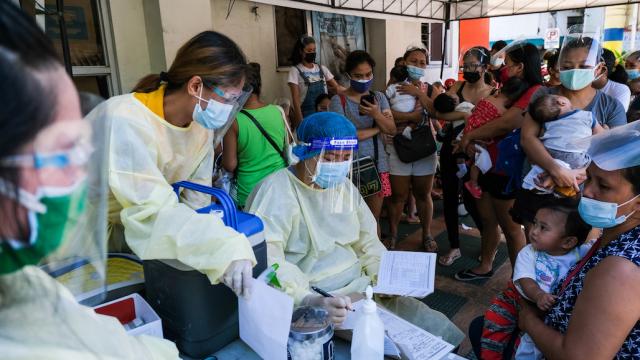 People queueing for their babies' vaccine shots in the Philippines.