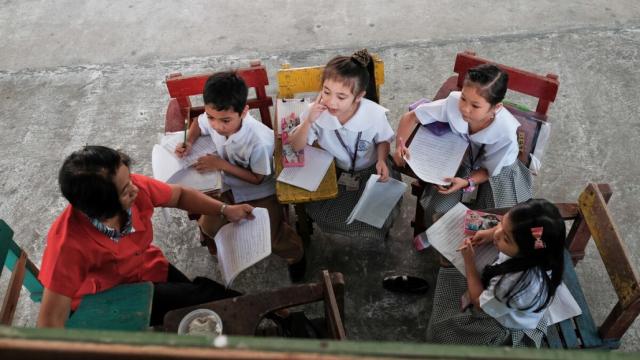 School children attend to their daily routine under the mentorship of volunteer teachers.  Photo credit: ADB.