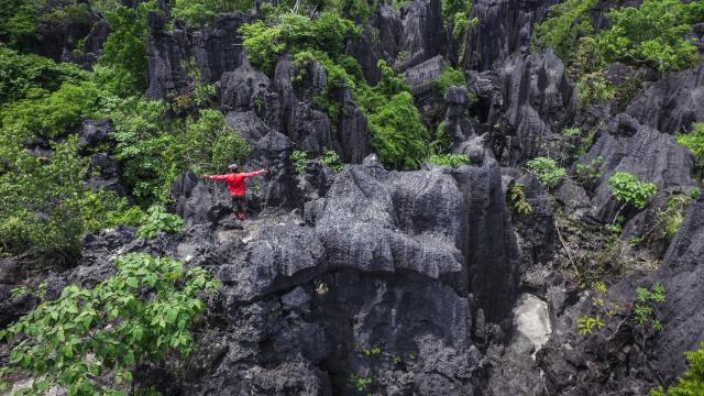 A man enjoying the Ramang-Rammang forest of rock in Sulawesi.