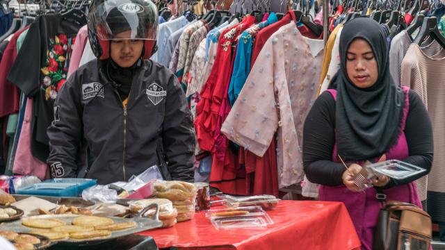 People milling around a market in Indonesia.